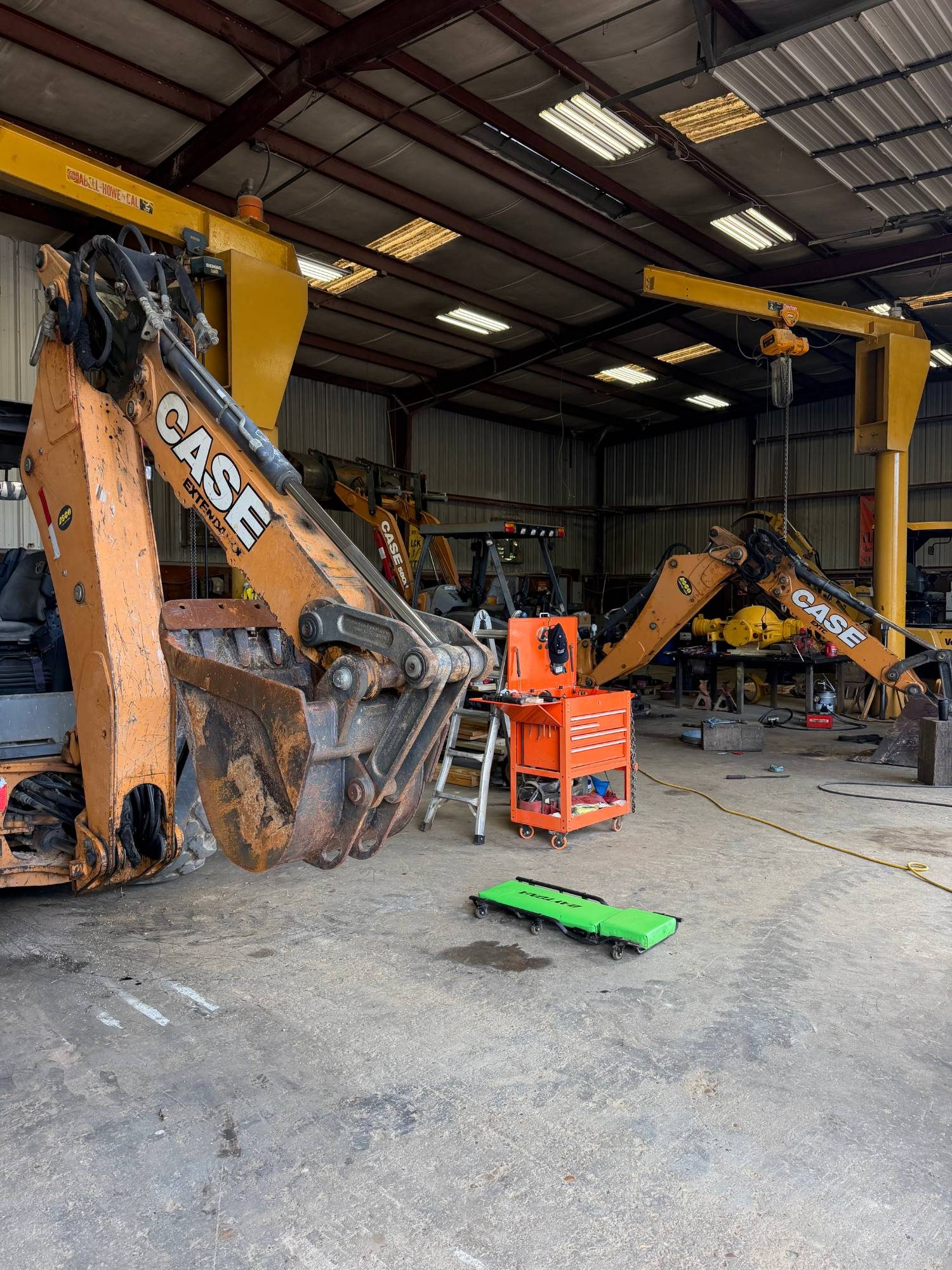 Case backhoes under the jib cranes in the Arch Machinery shop